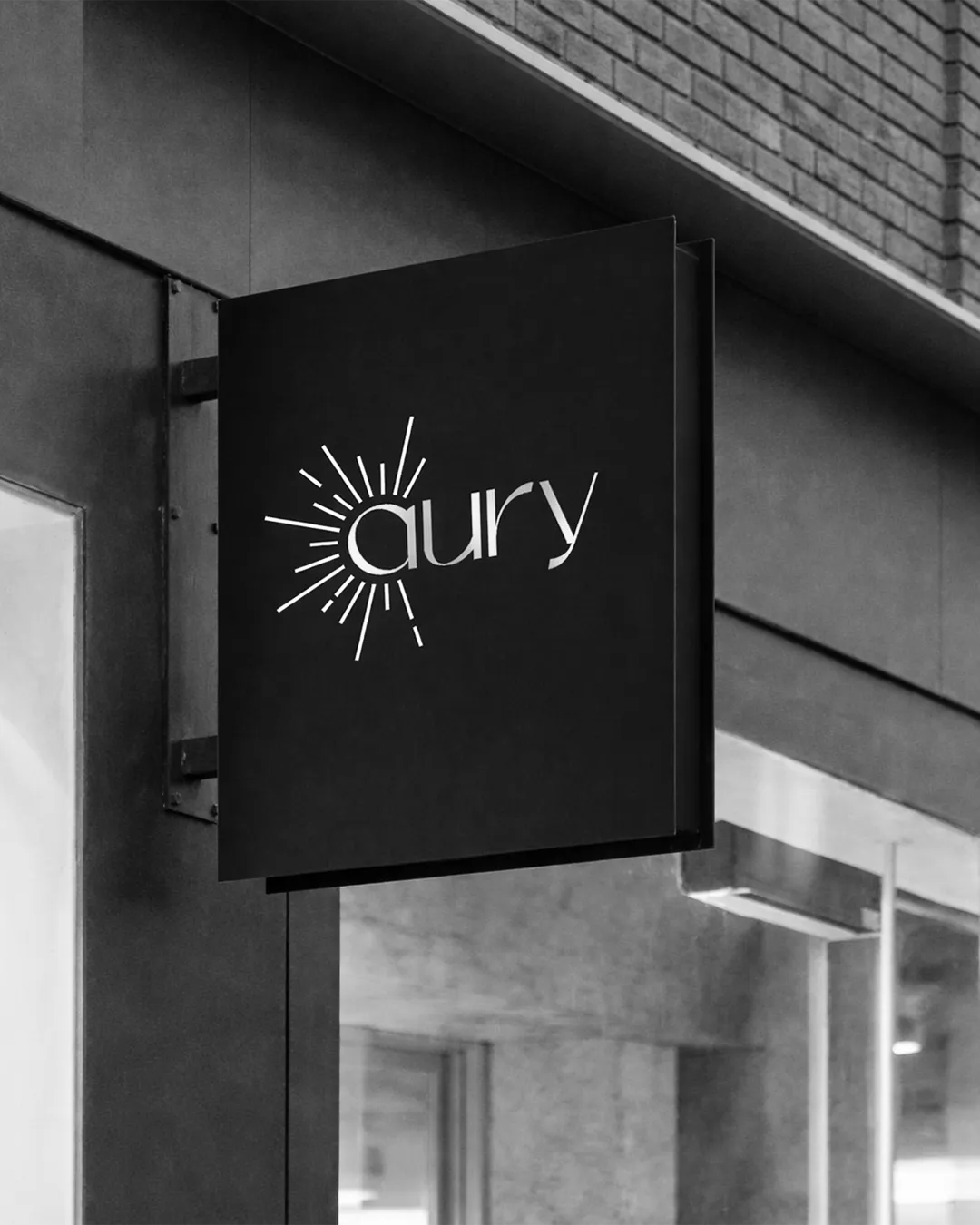 Cartel exterior de local con el logo de Aury en fondo oscuro